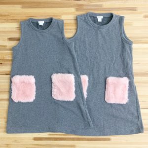 Matching grey dresses with pink fuzzy pockets